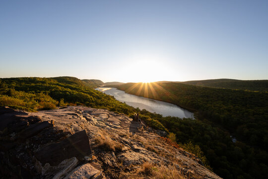 Two people observing scenic sunrise over Lake of the Clouds, Michigan