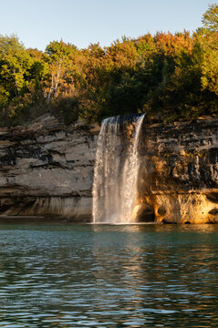 Spray Falls waterfall flowing into Lake Superior at Pictured Rocks