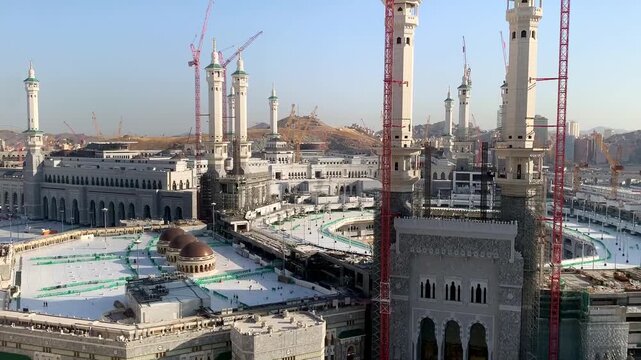Morning view of the exterior of Masjid al-Haram in Makkah, showing the grand mosque architecture and surrounding sacred atmosphere