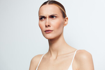 Woman portrait skincare beauty face spa wellbeing smooth skin closeup, gentle moisturiser routine, calm expression, soft studio light on clean background, wellness and self care concept