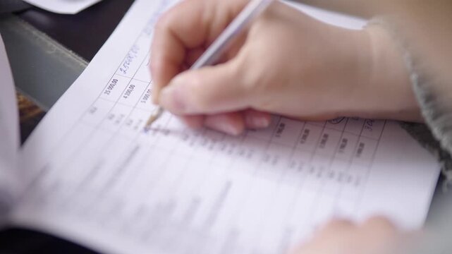 Accountant Marking Data In Paper Report. Management Information Processing. Financial Documentation Review