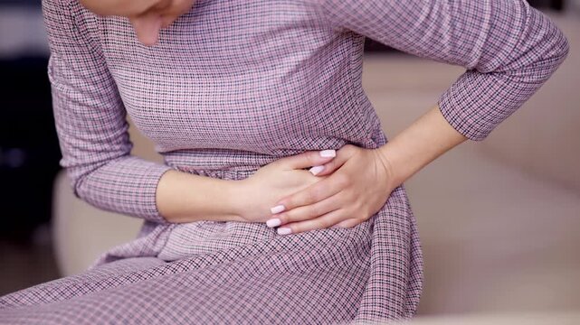 Woman Holding Stomach And Ribs Due To Abdominal Ache. Gastritis Or Pancreatitis Attack