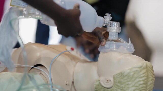 Paramedic practicing bag-valve-mask ventilation on a dummy
