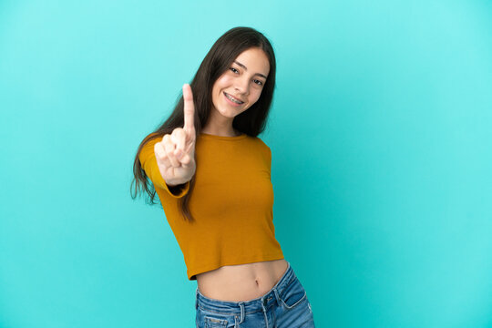 Young French woman isolated on blue background showing and lifting a finger