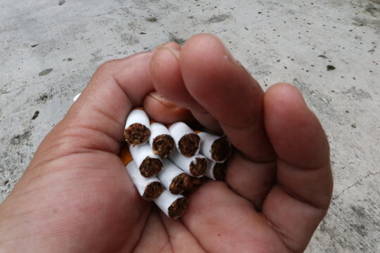 hand holding cigarettes, clove cigarettes from Indonesia
