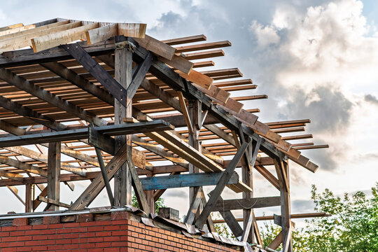 Weathered wooden beams above brick, dusk tones and softened shadows reveal signs of decay and preservation planning, structural survey atmosphere focusing