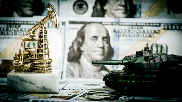 Oil pump and tank sit beside currency and portrait
