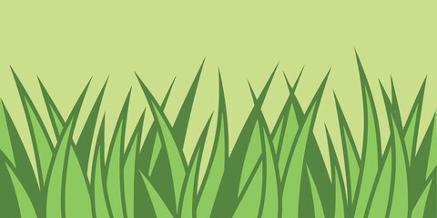 Fototapeta premium Green grass blades on a light green background with simple