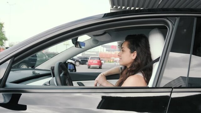 Woman driving car, male instructor showing thumbs up. Slow motion