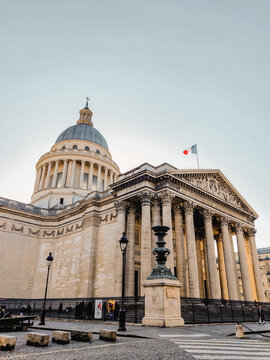 Panth&eacute;on mausoleum with French flag and Corinthian columns at sunrise, Paris, France &ndash; Editorial use only.
