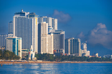 Fototapeta premium Panoramic view of the beach and skyscrapers in center of the tourist resort city of Nha Trang in Vietnam in Asia by the sea