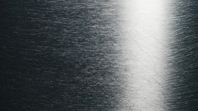 Metallic surface transition showing brushed texture from light to dark, highlighting reflections and patterns across three sequential frames in a continuous flow