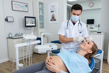 Fototapeta premium Pregnant Woman Receiving Dental Care from Male Dentist at the Clinic