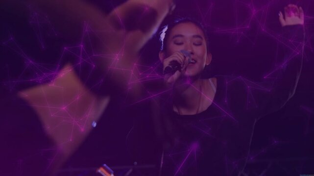 Singer starting music leaning mic engaging audience reaching hands, purple web across singer hands