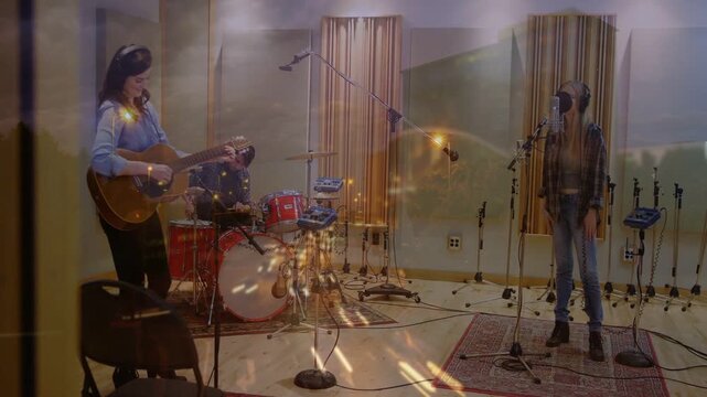 Studio take starting, guitarist strumming, drummer playing, vocalist singing, warm spark overlaying