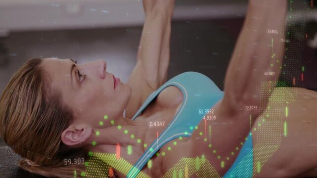 Woman starting rep pressing dumbbells for fitness, candlestick overlay appearing tracking motion