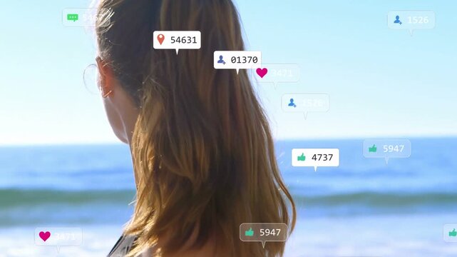 Woman entering shoreline, turning head and creating floating social icons around her for marketing