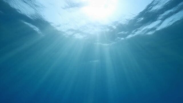Sunlight Filtering Through Ocean Surface Creating God Rays In Deep Water
