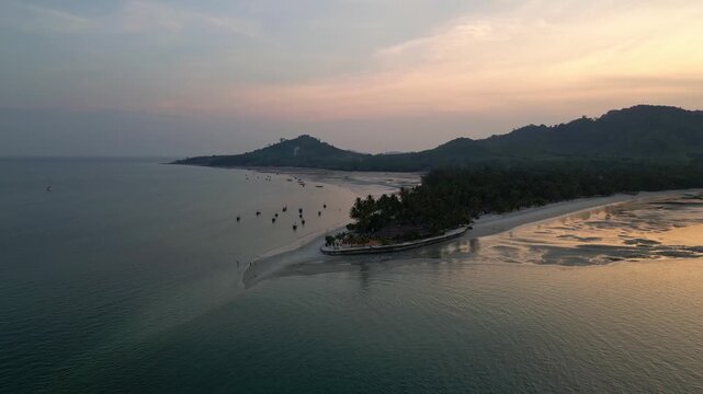 Koh Muk, Thailand: Aerial drone of the sunset over Koh Mook tropical island famous for its triangle beach in the Andaman sea in south Thailand. Shot with an orbit motion around seafront resort