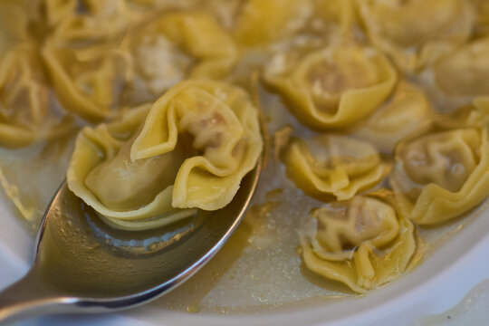 Emilia-romagna tortellini in broth with spoon