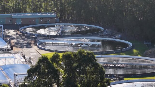 Aerial view of industrial wastewater treatment plant with circular clarifiers and aeration basins.