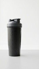 Obraz premium Ultra realistic dark protein shaker bottle mockup on clean white background with professional studio lighting minimal composition modern fitness hydration concept commercial advertising 