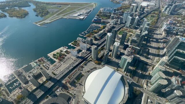 Toronto , Canada - 4k aerial video footage of Harbourfront district with traffic moving on the roads and with Billy Bishop Toronto City Airport located on  Toronto Islands in Lake Ontario 