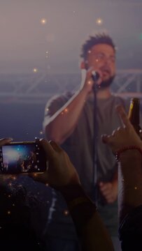 Vertical video: phone causing camera pan, lead singer stepping center and singing into mic at gig