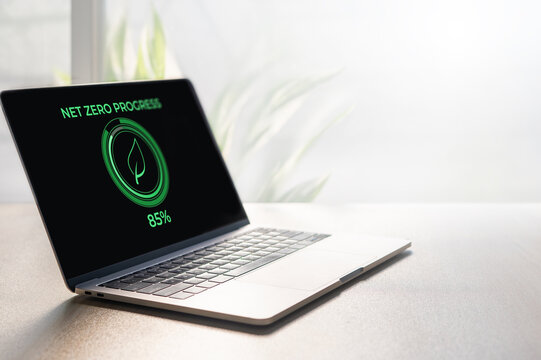 Net Zero Progress Indicator with Green Energy Icon on Laptop Screen