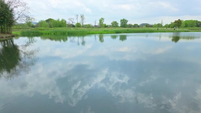 The reflection of natural scenery on the lake surface of Liangzhu Ancient City Ruins Park