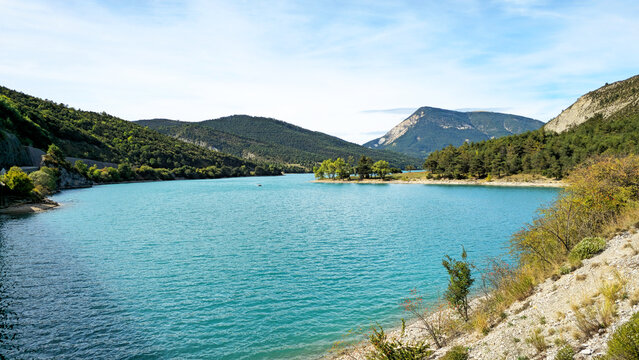 Lake Lac de Castillon with blue water and green mountains, Alpes-de-Haute-Provence, France, Europe.
