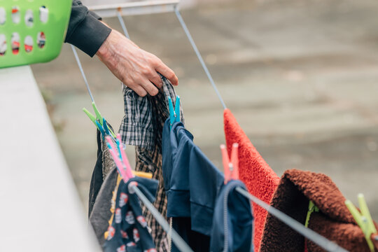 close-up of hands hanging out the laundry