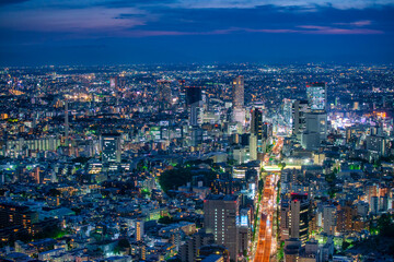 Naklejka premium Aerial view of Tokyo Roppongi district skyline and skyscrapers illuminated at night Japan