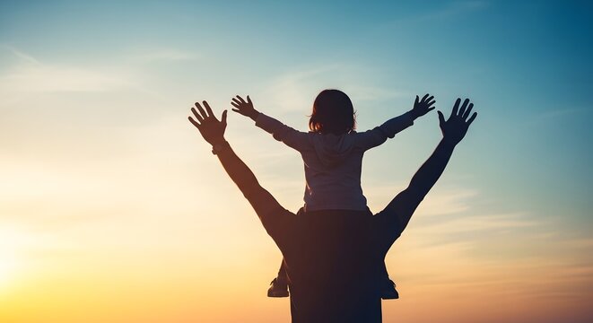 A heartwarming silhouette of a father carrying his child on his shoulders at sunset