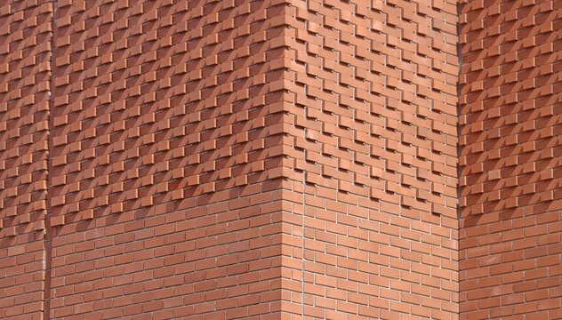Modern brick facade with geometric relief pattern and architectural texture