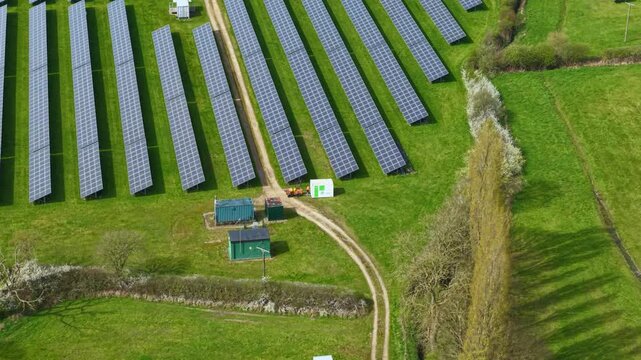 Top down aerial view of a solar farm with photovoltaic panels and transformers