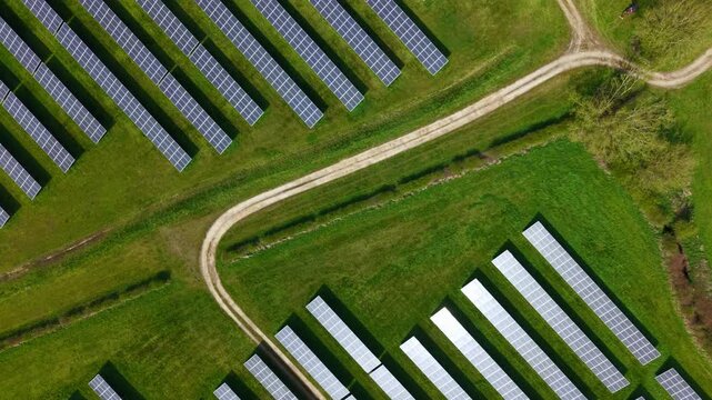 Top down aerial view of a solar farm with photovoltaic panels and transformers