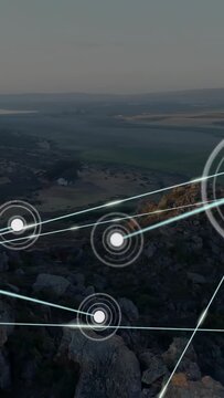 Vertical video: Orb appearing above ridge, emitting rings and beams, forming mesh mapping network