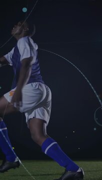 Vertical video: Controlling soccer player in navy jersey receiving ball, propelling it past HUD
