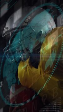 Vertical video: Camera panning up, football player gripping ball while HUD tracking ball metrics