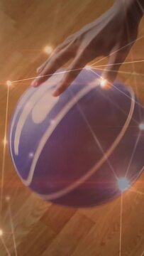 Vertical video: Opening with hand on purple ball, teen practicing dribbles on floor, wearing shorts