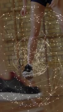 Teenage player placing foot on basketball, initiating footwork drill with rotating particle sphere