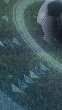 Soccer ball rolling across grass with broadcast graphics and boot blur on right, copy space