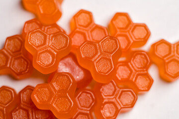Jelly gummies close-up, fruit vitamins on bright background, food supplements.Orange vitamins...