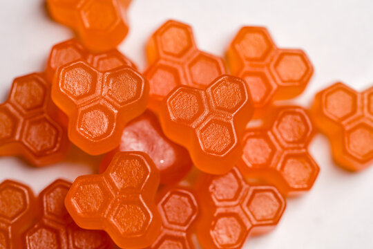 Jelly gummies close-up, fruit vitamins on bright background, food supplements.Orange vitamins candies