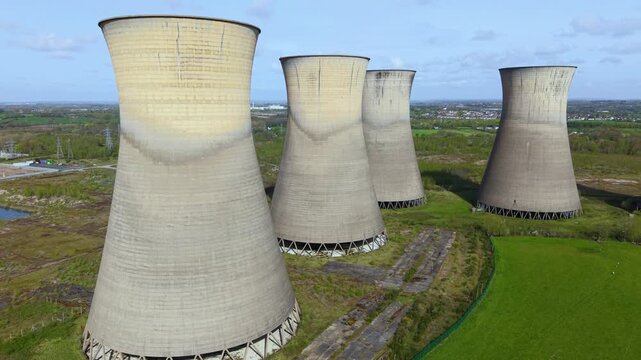 Aerial drone view of the decommissioned Willington B Power Station cooling towers, derelict industrial landmarks in Derbyshire, United Kingdom.