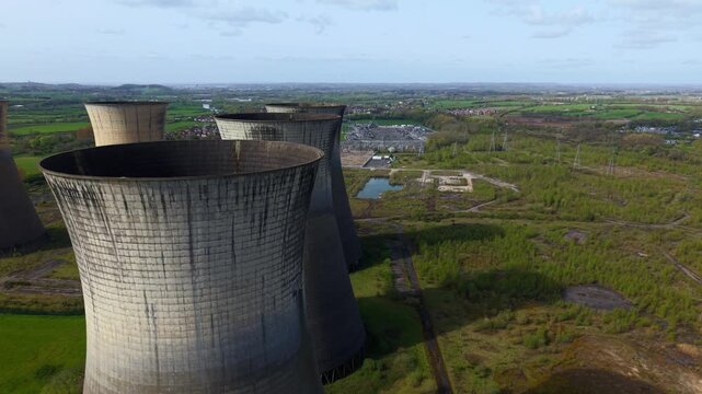 Aerial drone view of the decommissioned Willington B Power Station cooling towers, derelict industrial landmarks in Derbyshire, United Kingdom.