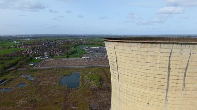 Industrial ruins of Willington B cooling towers with high voltage electrical substation in background