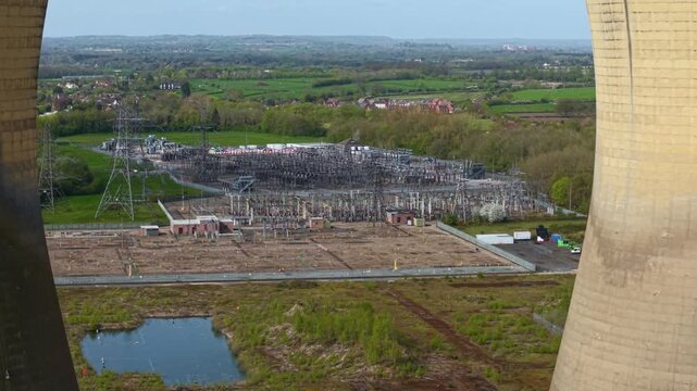 Industrial ruins of Willington B cooling towers with high voltage electrical substation in background