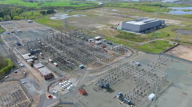 Top down perspective of the National Grid substation at Drakelow, featuring high voltage transformers and pylons in Derbyshire, England.
